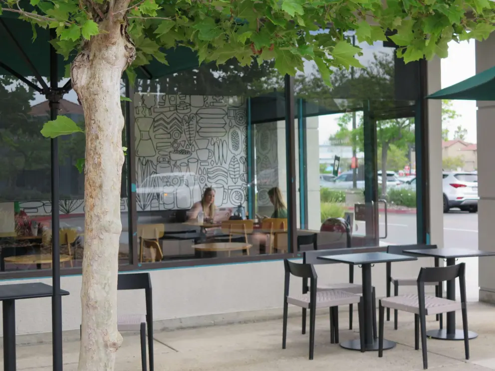 Friends talking inside Starbucks at Twin Peaks Shopping Center. 