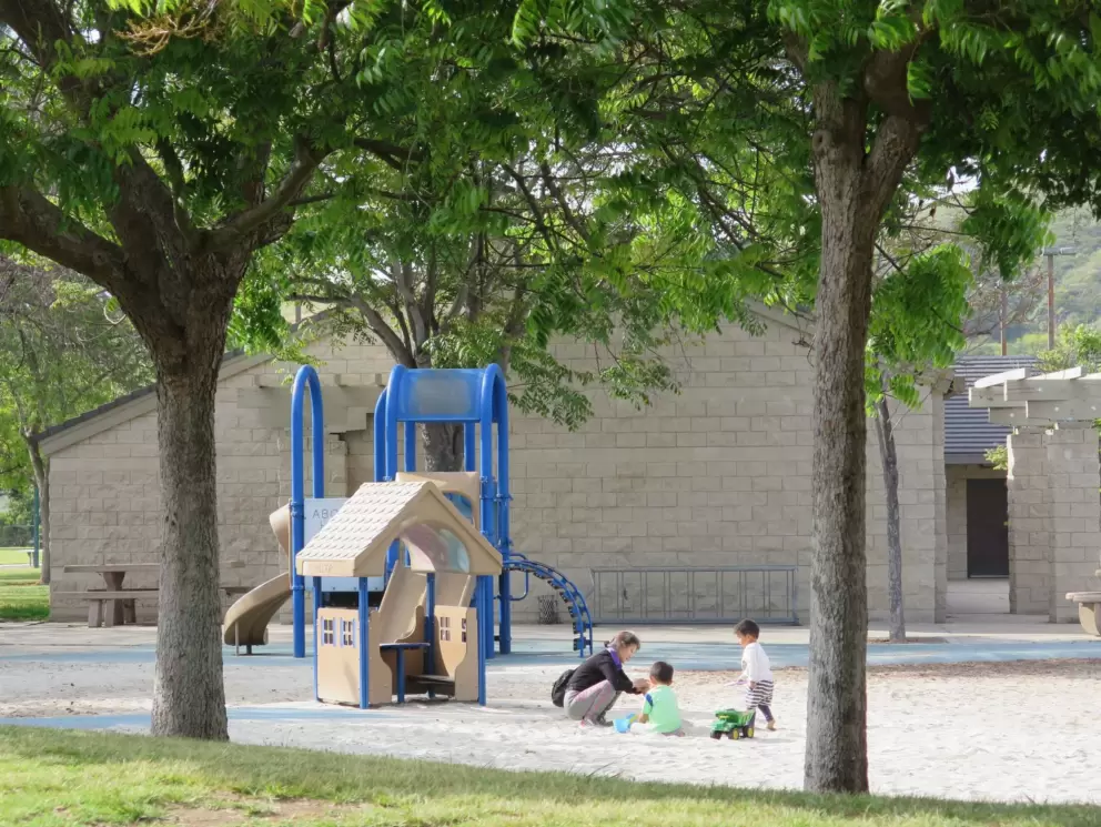 Playing in the sand by the play house. 