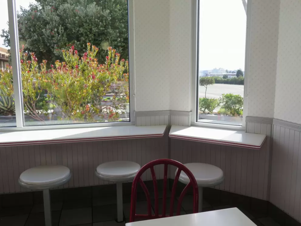 Cute window seating at In-N-Out Burger, a place where you can eat, nearby.