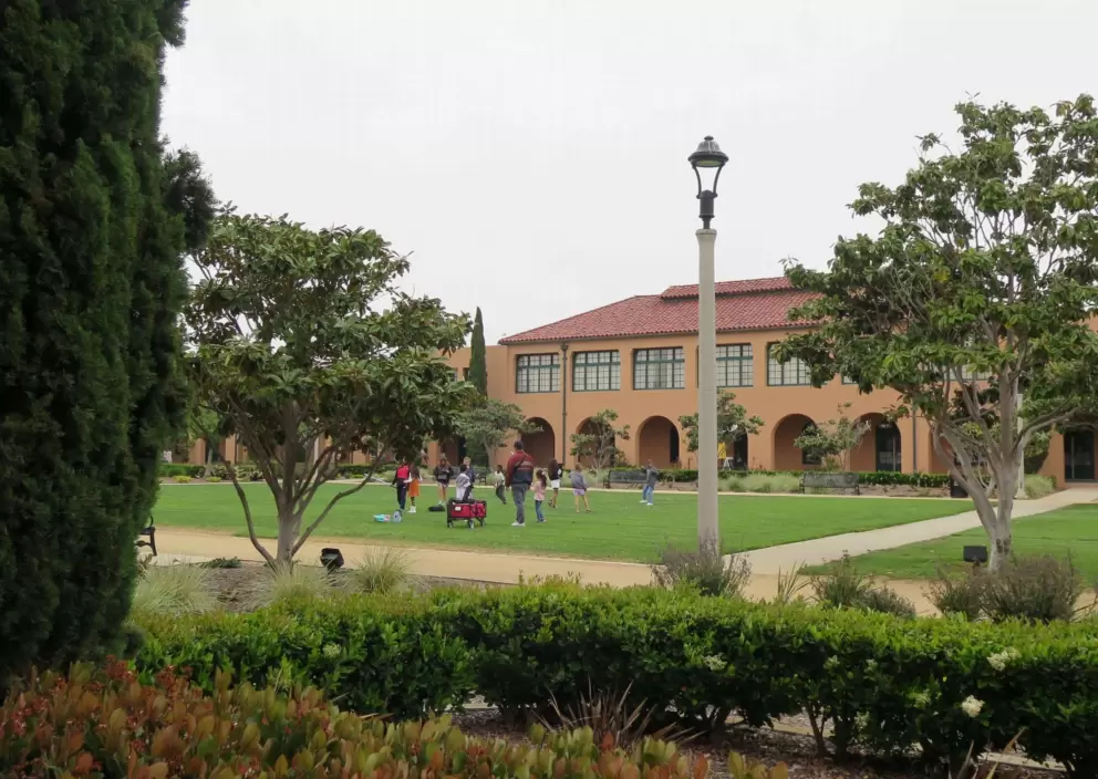 Kids gather on the huge square lawn. 