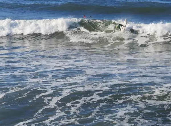 A surfer does a trick during the SLO Cal Surf Contest. 