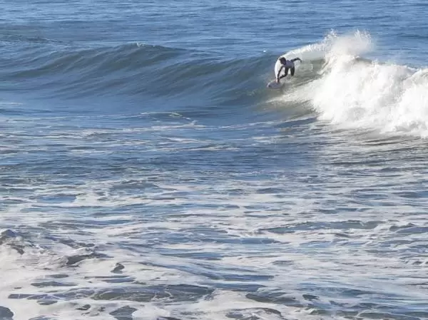 A surfer carving through a wave, during the SLO Cal Surf Contest. 