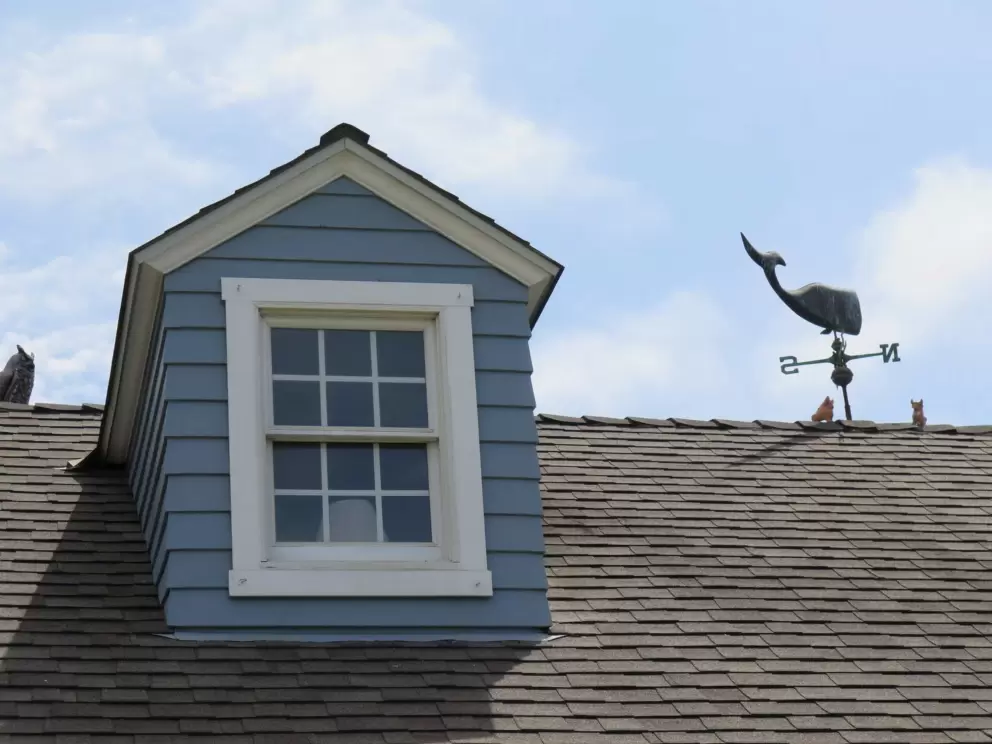 House with whale weathervane. 
