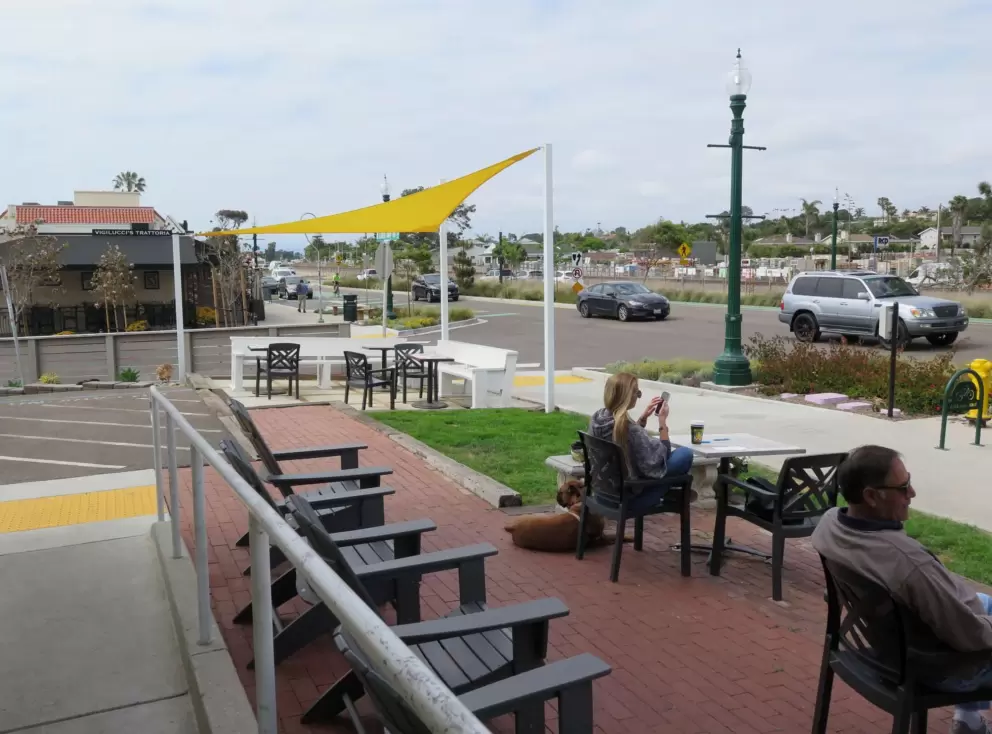 You are sitting by the road when you are at the cafes. 