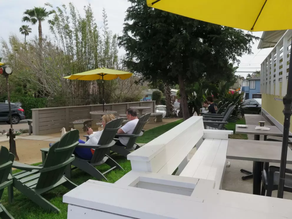 Side seating with adirondack chairs at Pannikin Coffee and Tea. 