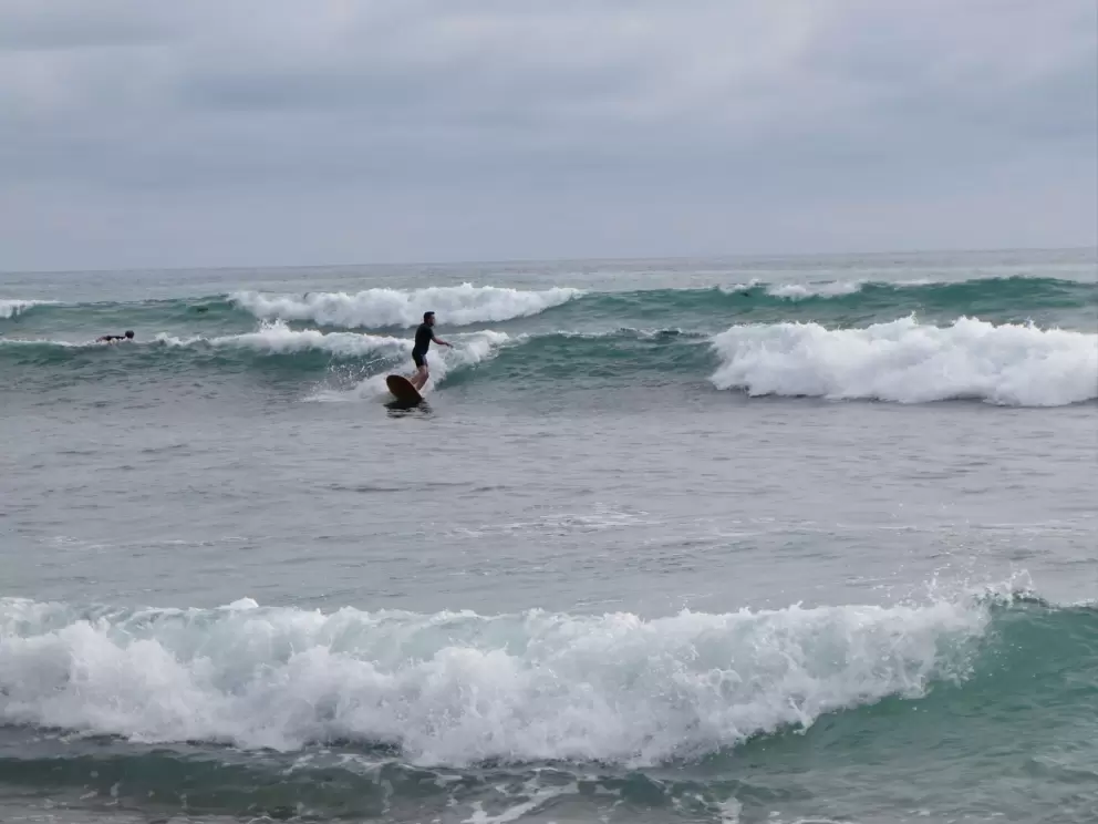 Riding a wave in to shore. 