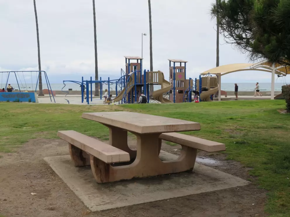 Picnic table with view of the swings and playground. 