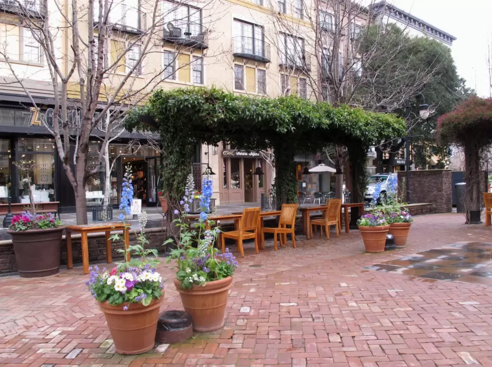 Brick square where people can hang out, toddlers can dance, and chess players can compete at the tables.