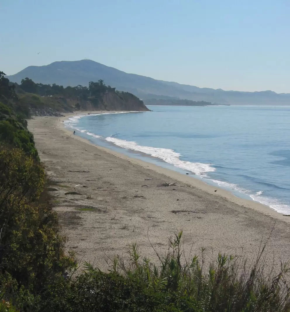 Looking down at the curve of beach.