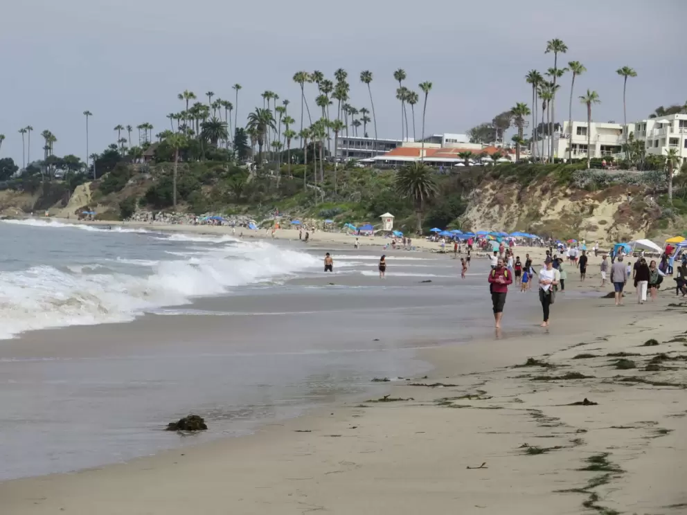 People walking along the beach. 