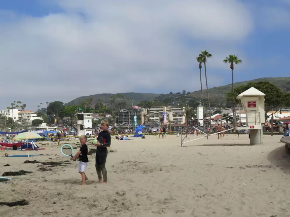 Lifeguard shack, and boys playing at the beach. 