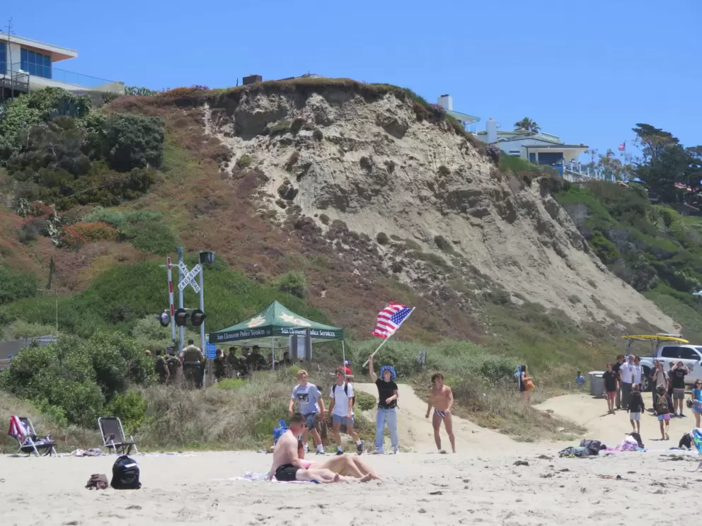 Beachgoers carry an American flag on July 4. 