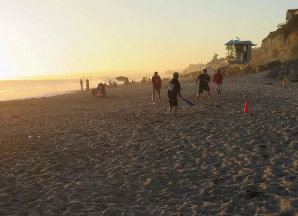 Playing baseball on the sand. 