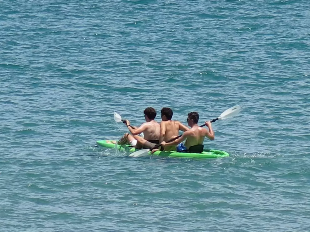 Kayakers head out to sea. 