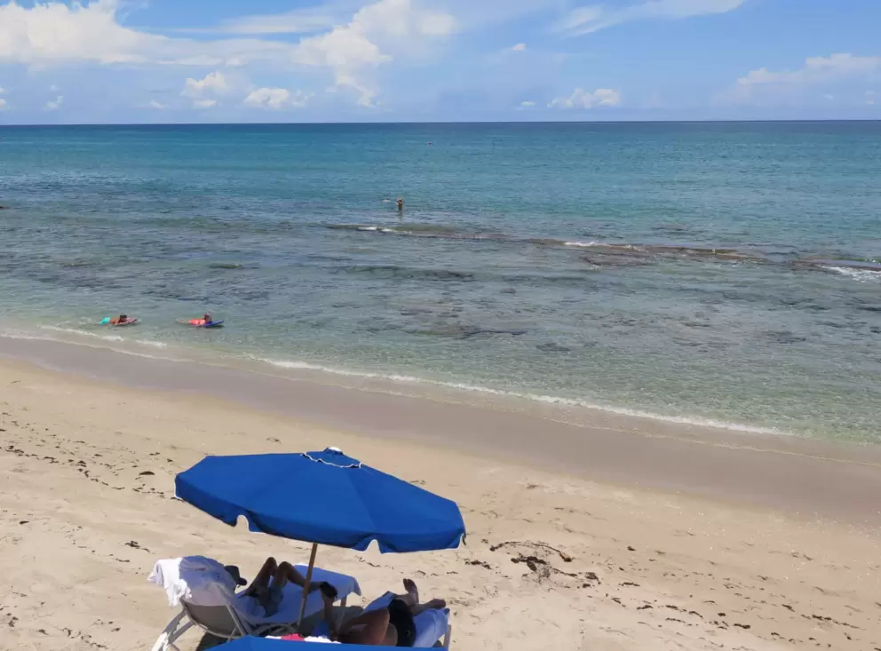 Relaxing under an umbrellas while your kids play at the shore!