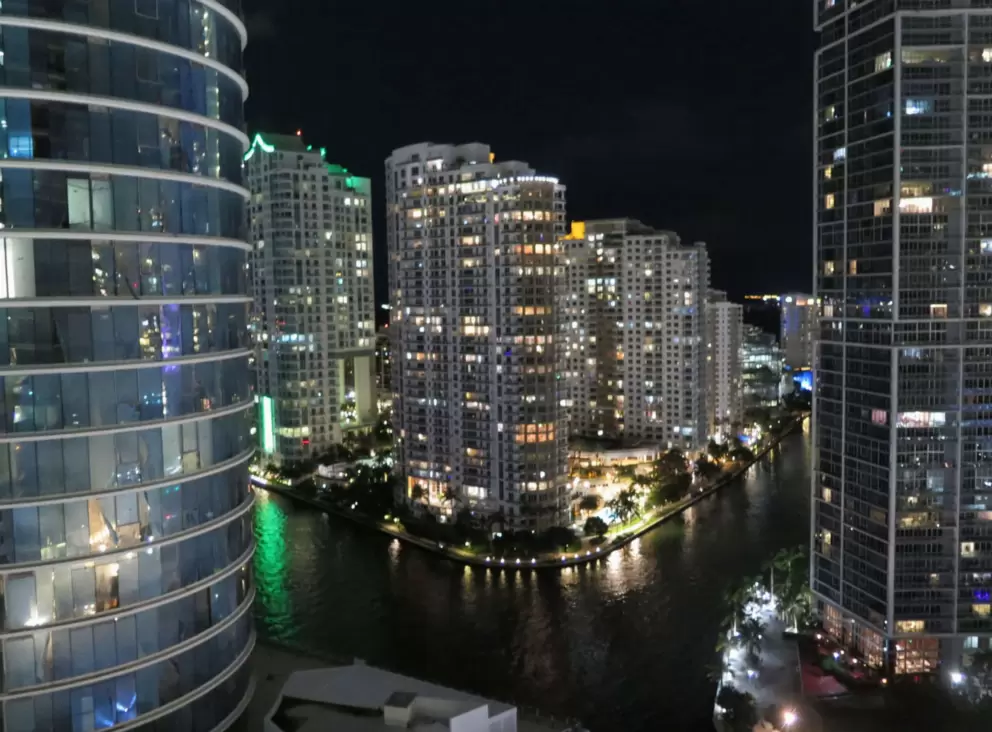 Rounded highrise and squared highrise, with Brickell Key in the middle, as seen from Kimpton Epic. 