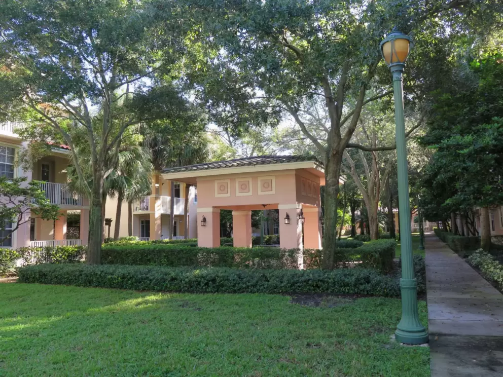 Pink square gazebo by a shady walk in the Village at Abacoa condos, near Abacoa Town Center. 