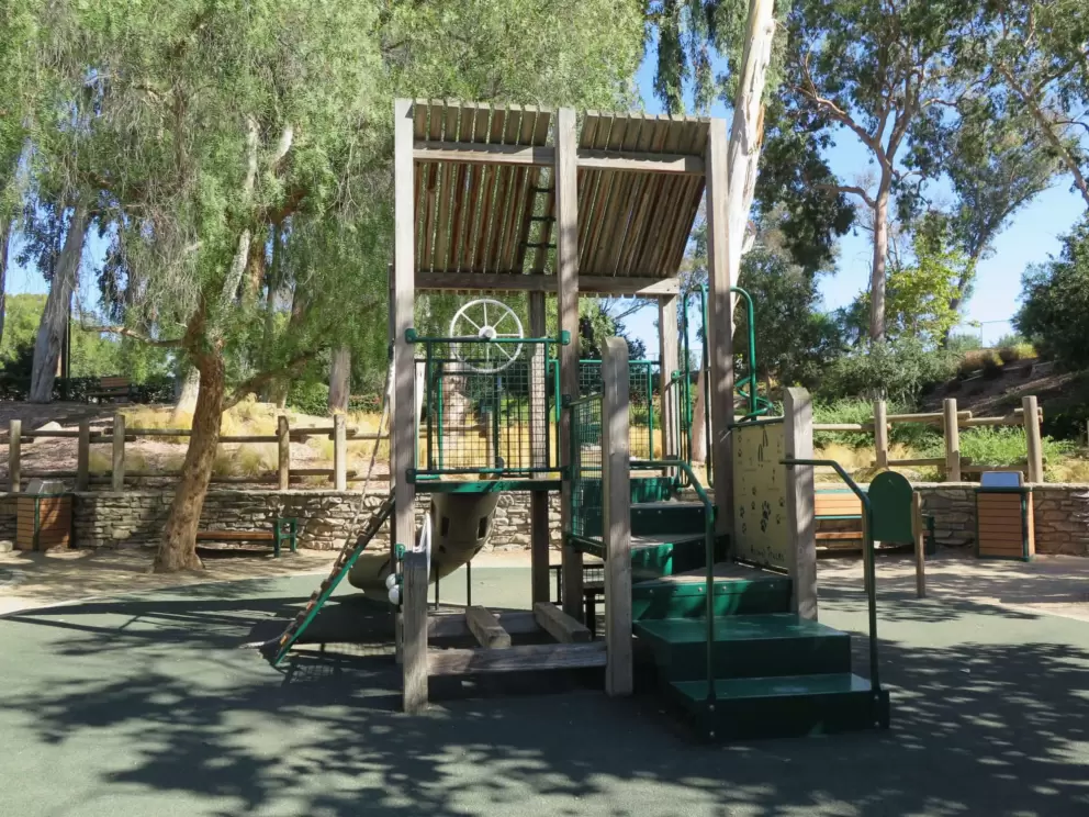 A steering whell on the playground. 
