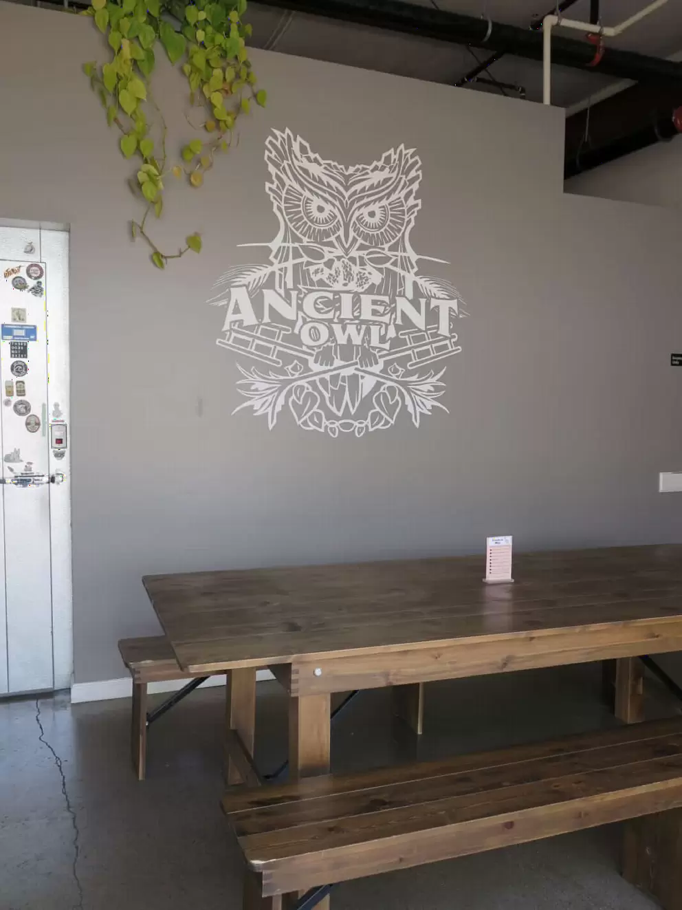 A long picnic table inside Ancient Owl. 