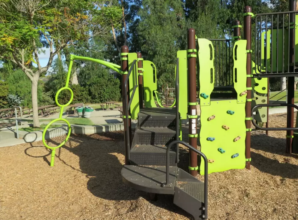 Spinner and rock climbing area on the play structure. 