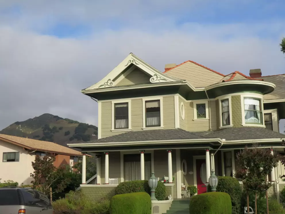 Ornate house on Buchon Street, with mountain behind. 