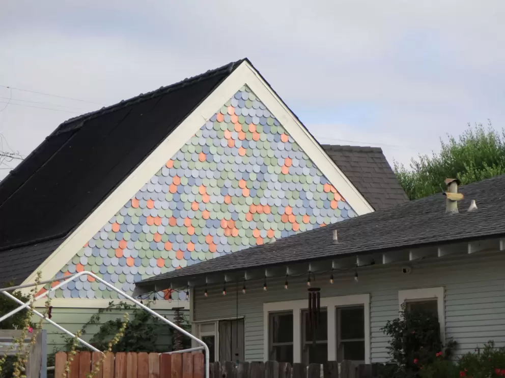 Multi-colored round shingles on a house gable. I love these!