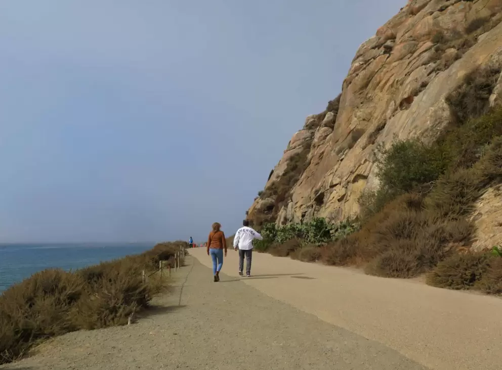 Walking at the very north end of the path where it goes around Morro Rock. 