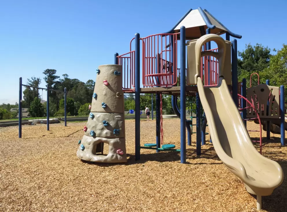 Slide and rock climbing area on the playground. 