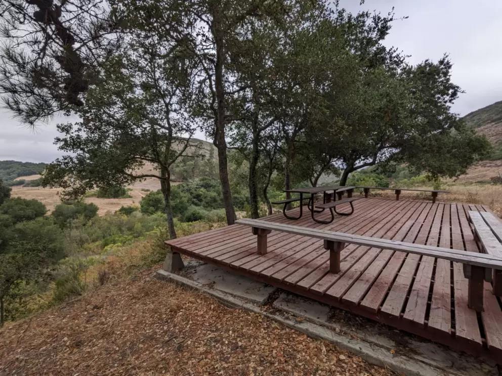 Wooden platform with picnic table and benches at Waddell Ranch Picnic Area. 
