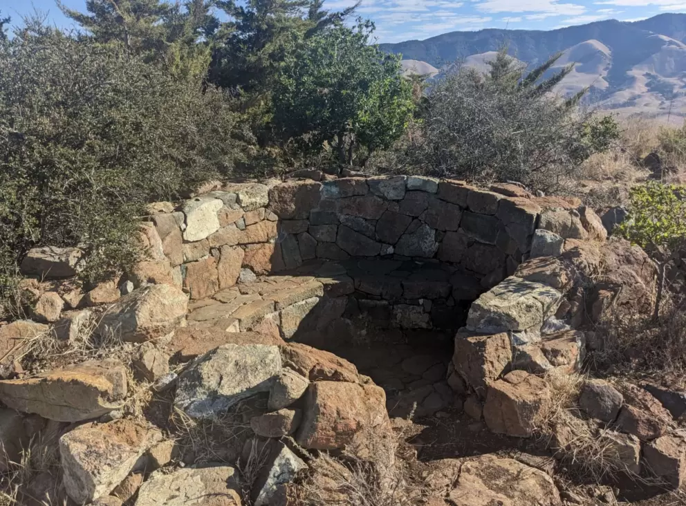 The stone bench at the end point of the hike, and view of the mountains in the back country. 