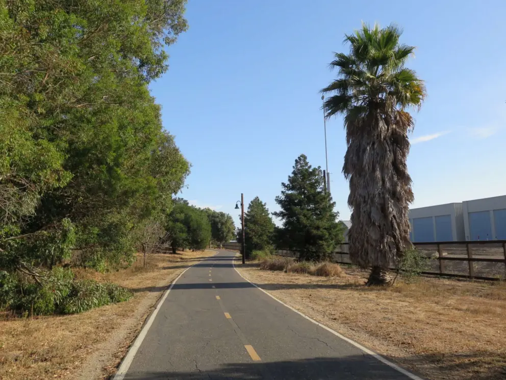 There are industrial buildings along the path. 