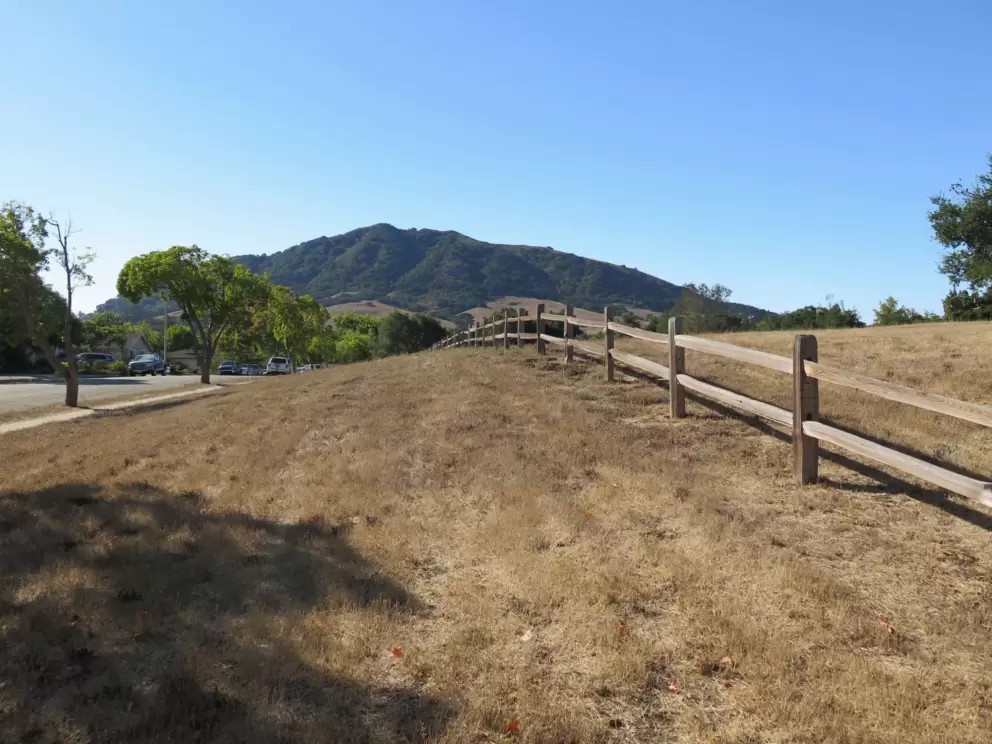 Wooden fence and open land on Jeffrey Drive. 