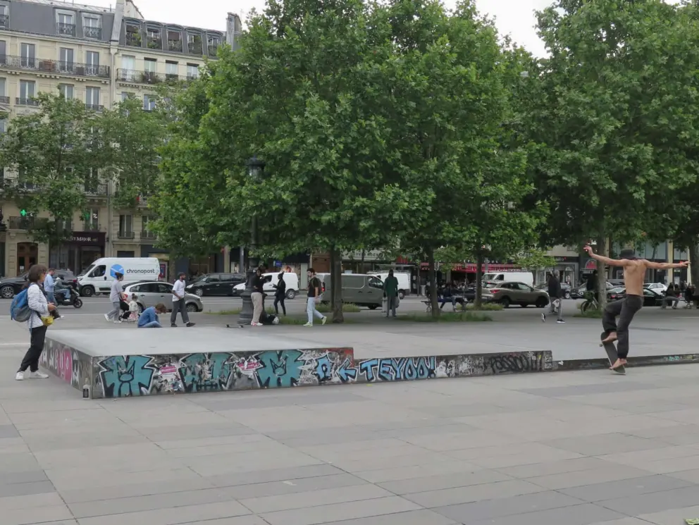 Graffiti and skateboarder at Place de la Republique. 