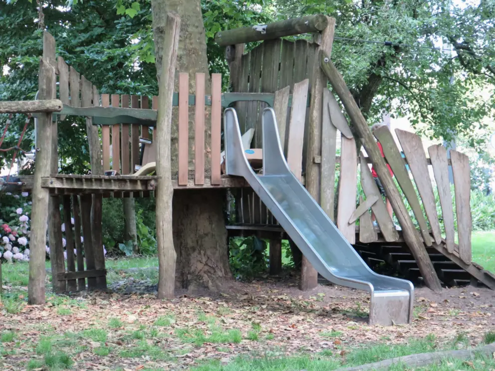 Slide at the wooden playground. 
