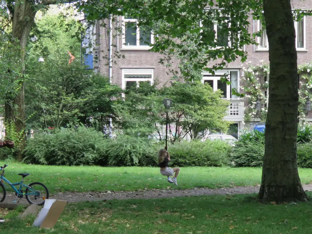 A girl rides the cable at the playground. 