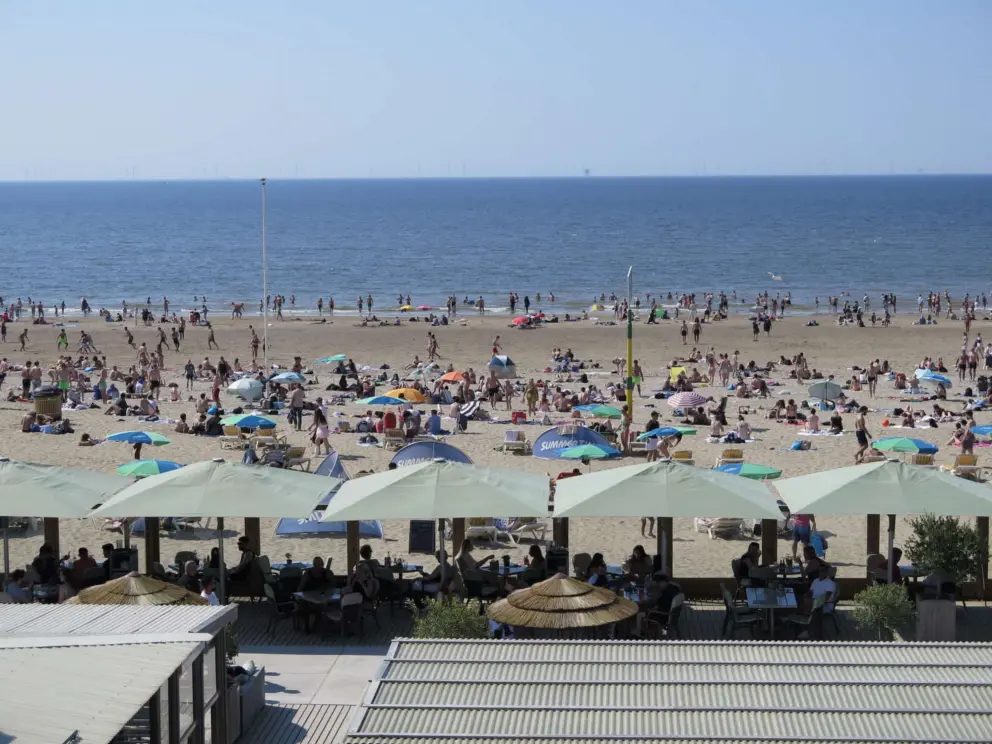 Summertime cafes and crowded beach. 