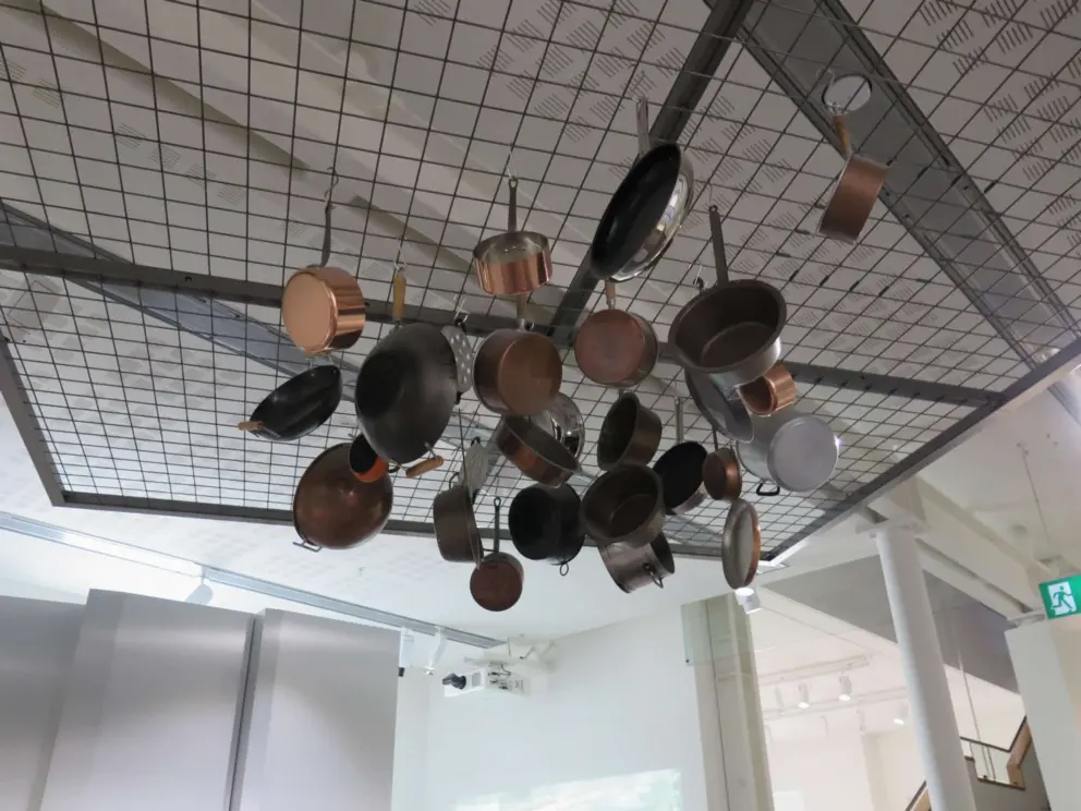 Pots and pans hanging from the ceiling. 