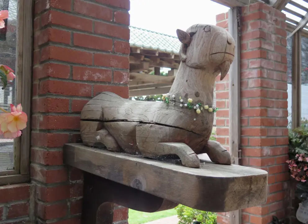 Wooden llama sculpture in the begonia house. 