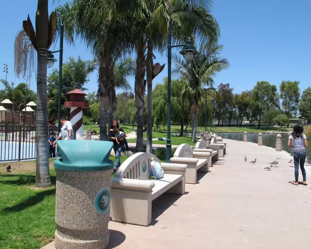 Lake, benches, and fenced playground.
