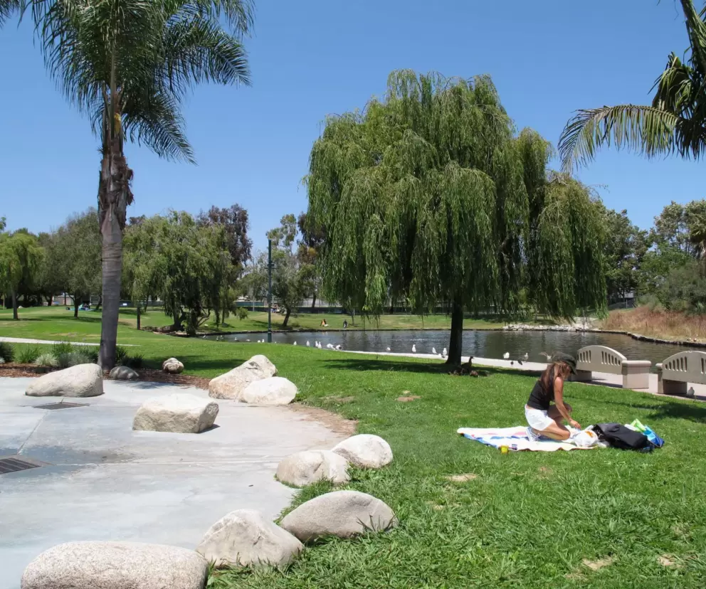 Sitting out on the grass by the splash pad.