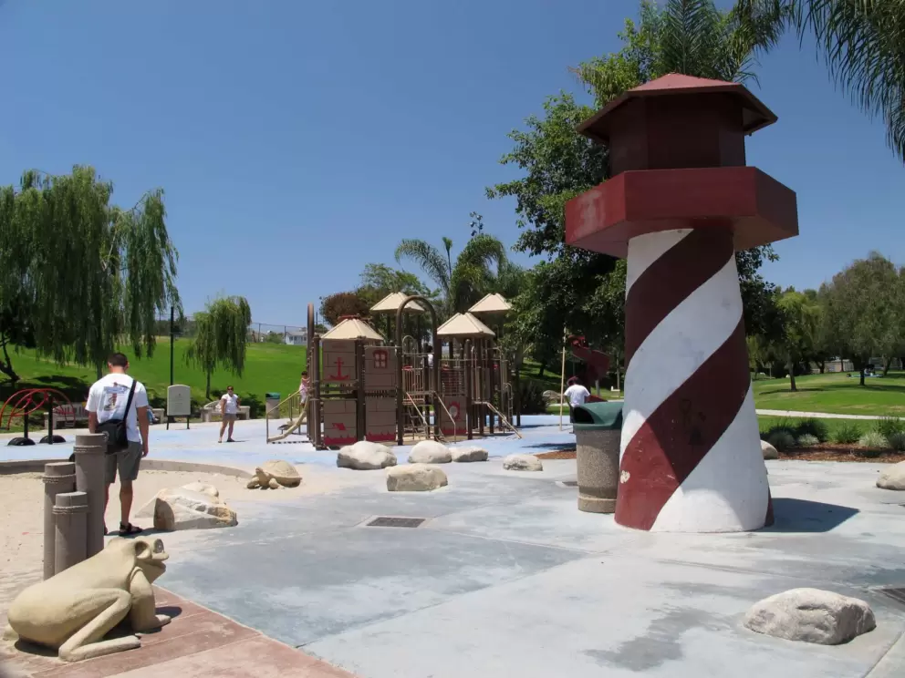 Lighthouse, splash pad, and frog sculpture.