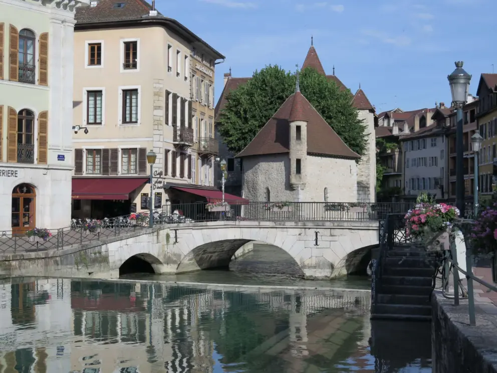 The Palais de l'Ile and arched pedestrian bridge over the river. 