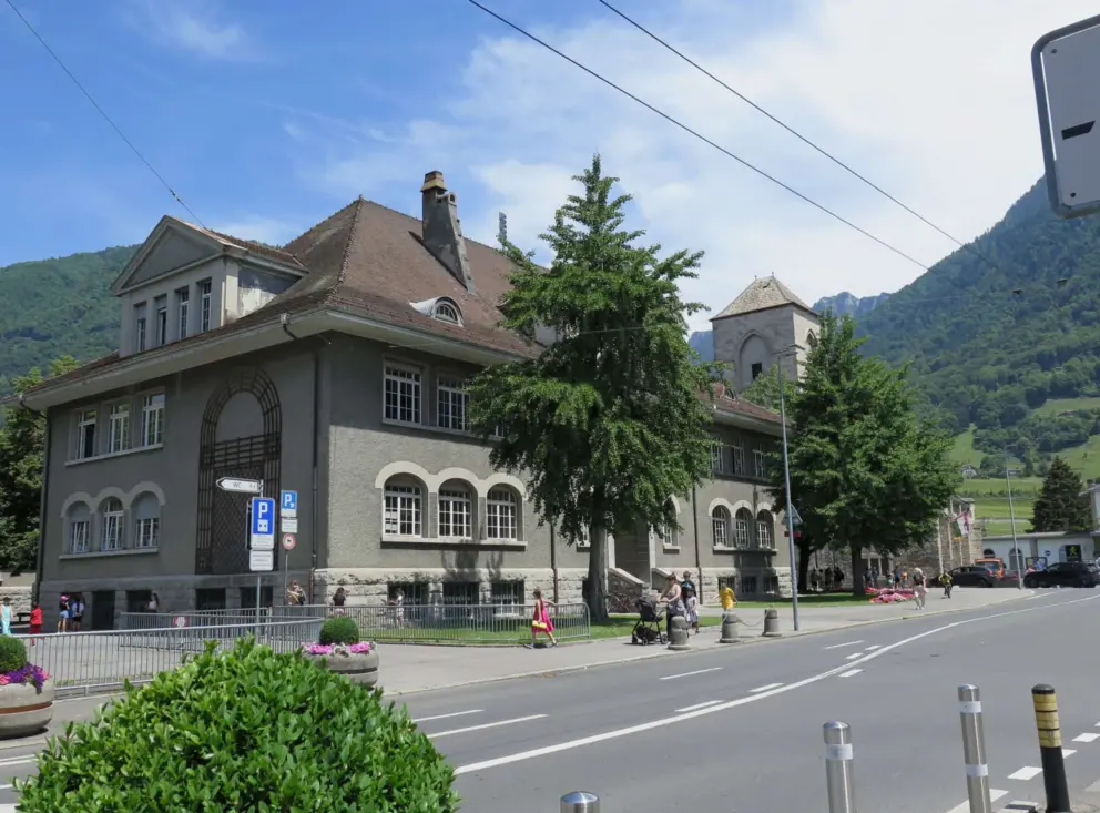 Building across from the train station, with arched windows. 