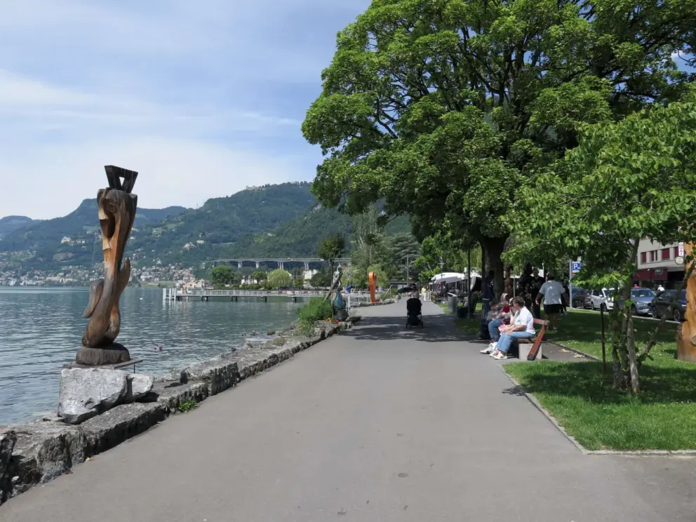 Sitting on benches at the waterfront. 