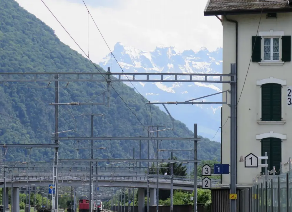 High mountains with snow, as seen in summer, at the train station. 