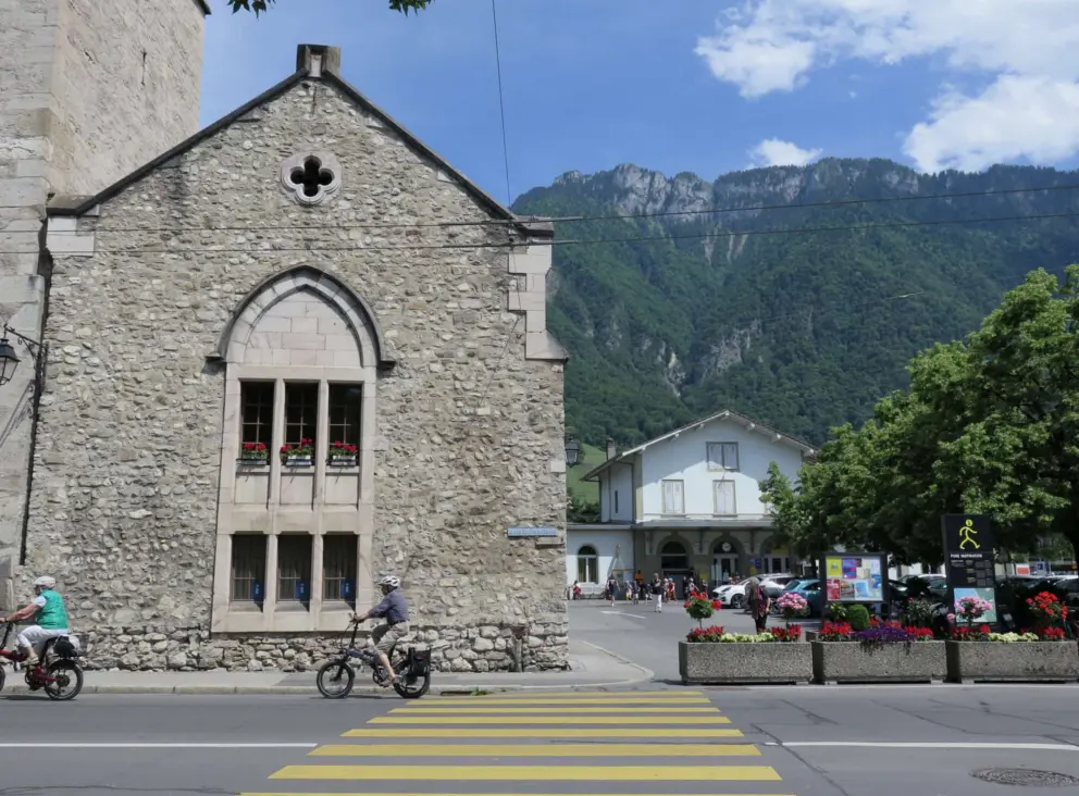 Stone building and mountains, near the train station. 