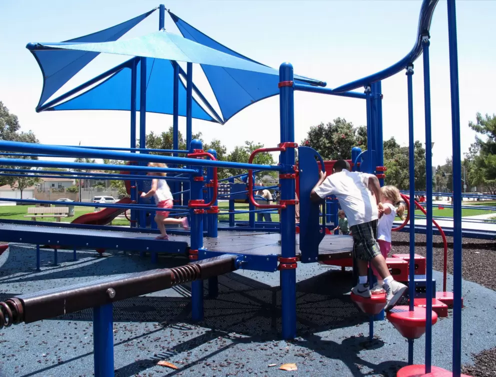 Playground in southeast corner, with blue shade canopy.