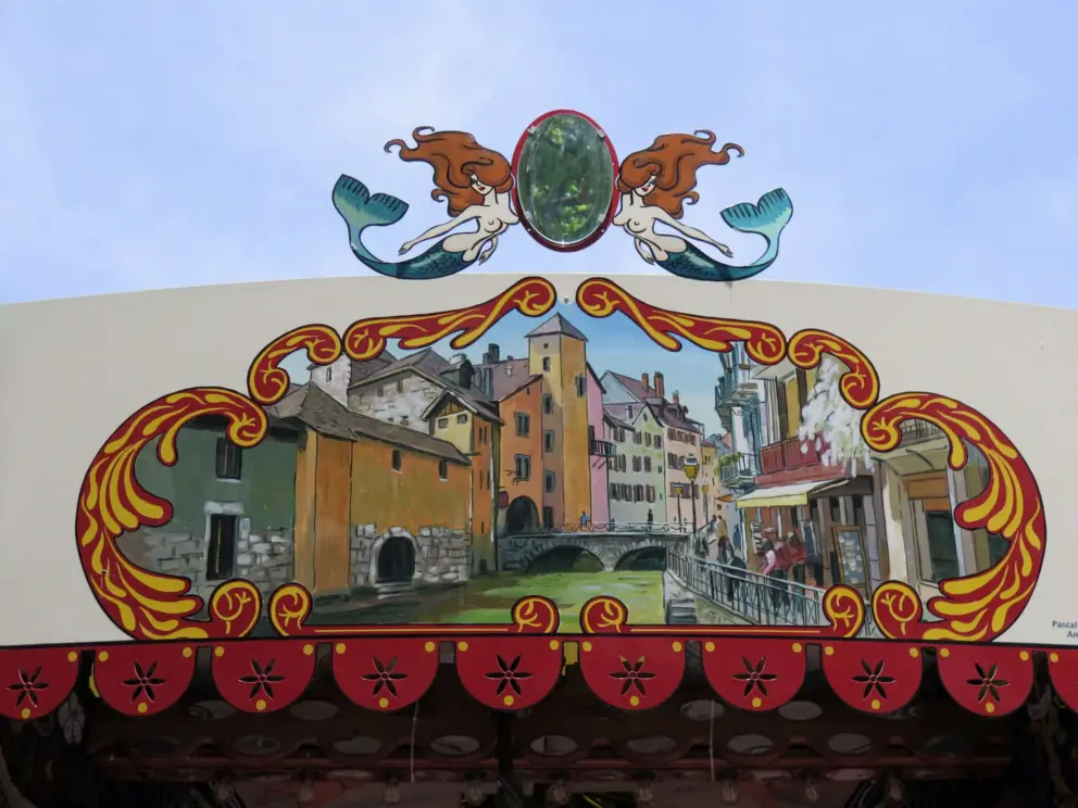 Picture of Annecy town on the top of the carousel, plus some very French mermaids. 
