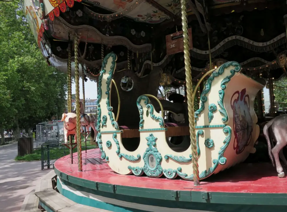 A carriage you can ride on the carousel. 