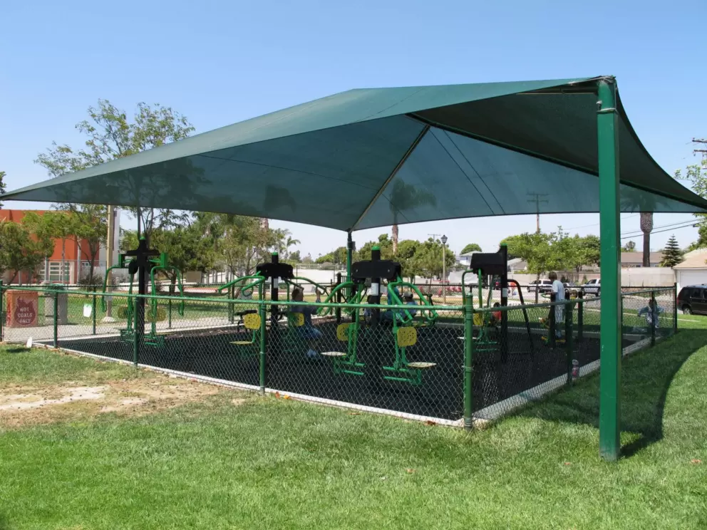 The workout playground under a green canopy.